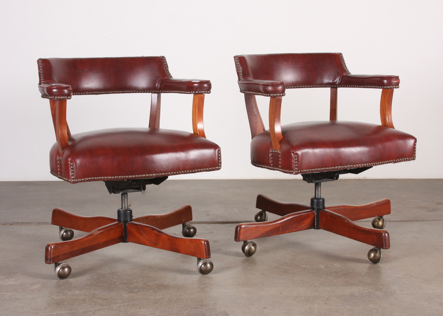 Two Red Leather Rolling Arm Chairs EBTH