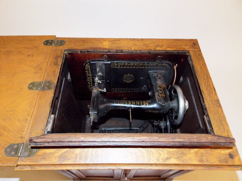 An Antique Minnesota Model B Treadle Sewing Machine in a Tiger oak EBTH