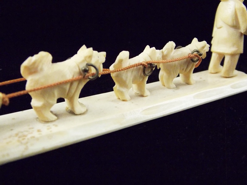 An Antique Inuit Carved Miniature Ivory Inuit and Dog Sled EBTH
