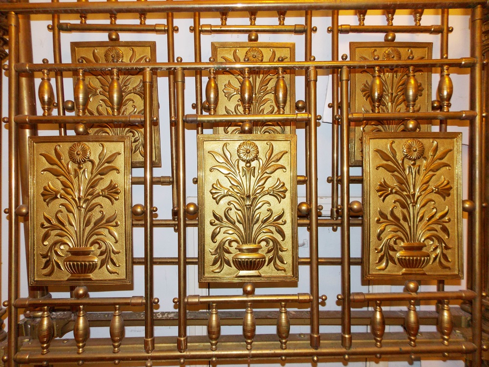 An Antique Brass Bed With Decorative Embossed Panels, Spindles and Finials EBTH