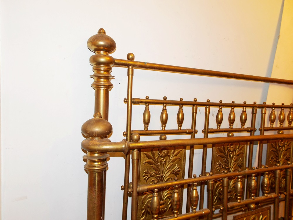 An Antique Brass Bed With Decorative Embossed Panels, Spindles and Finials EBTH