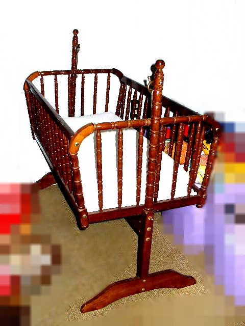 Wood Baby Crib With Turned Spindle Sides And Metal Rocking Hooks