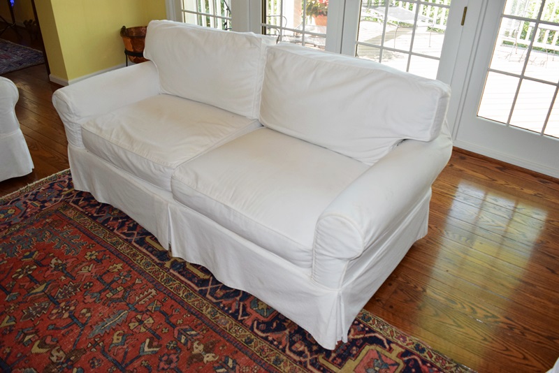 An Arhaus Two Cushion Sofa with White Canvas Slipcover EBTH