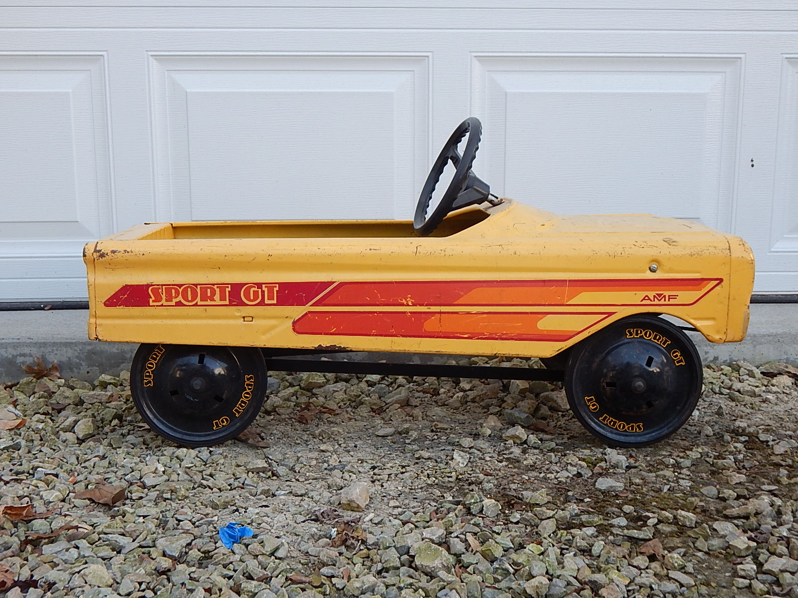 red and yellow pedal car