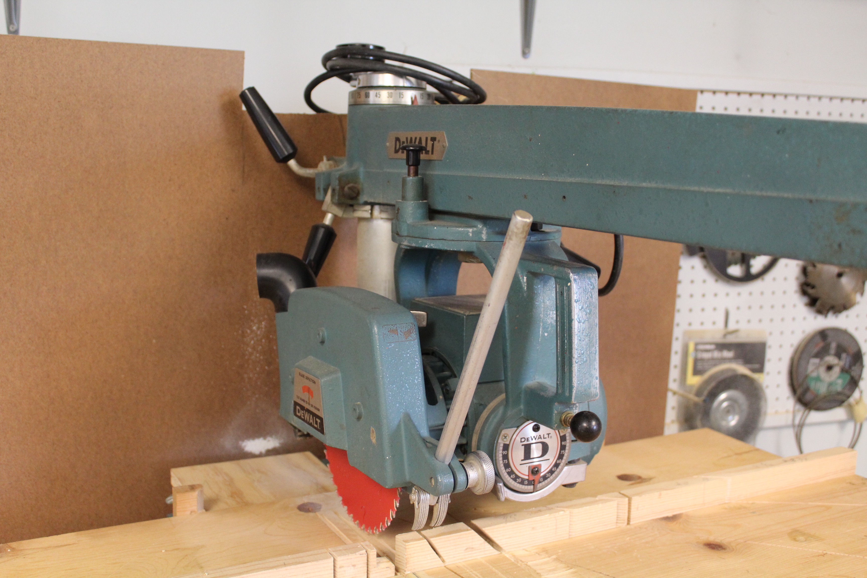 DeWalt Power Shop Radial Arm Saw on Stand and Wall of Blades EBTH