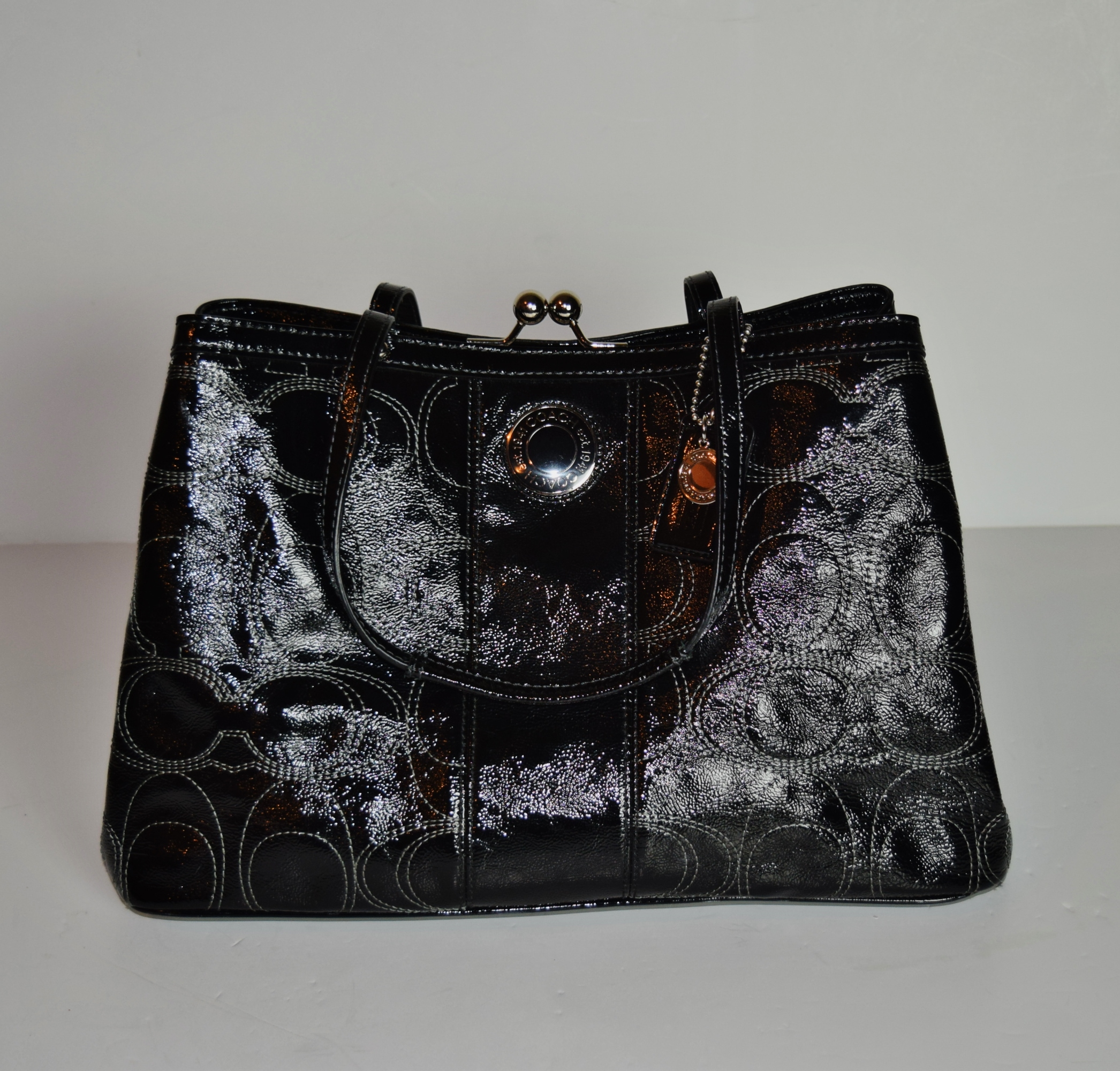 black patent coach purse