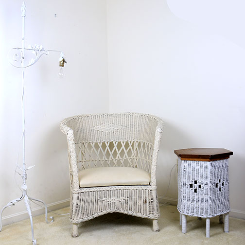 Barrel Back Wicker Chair With Iron Lamp And Wicker Side Table
