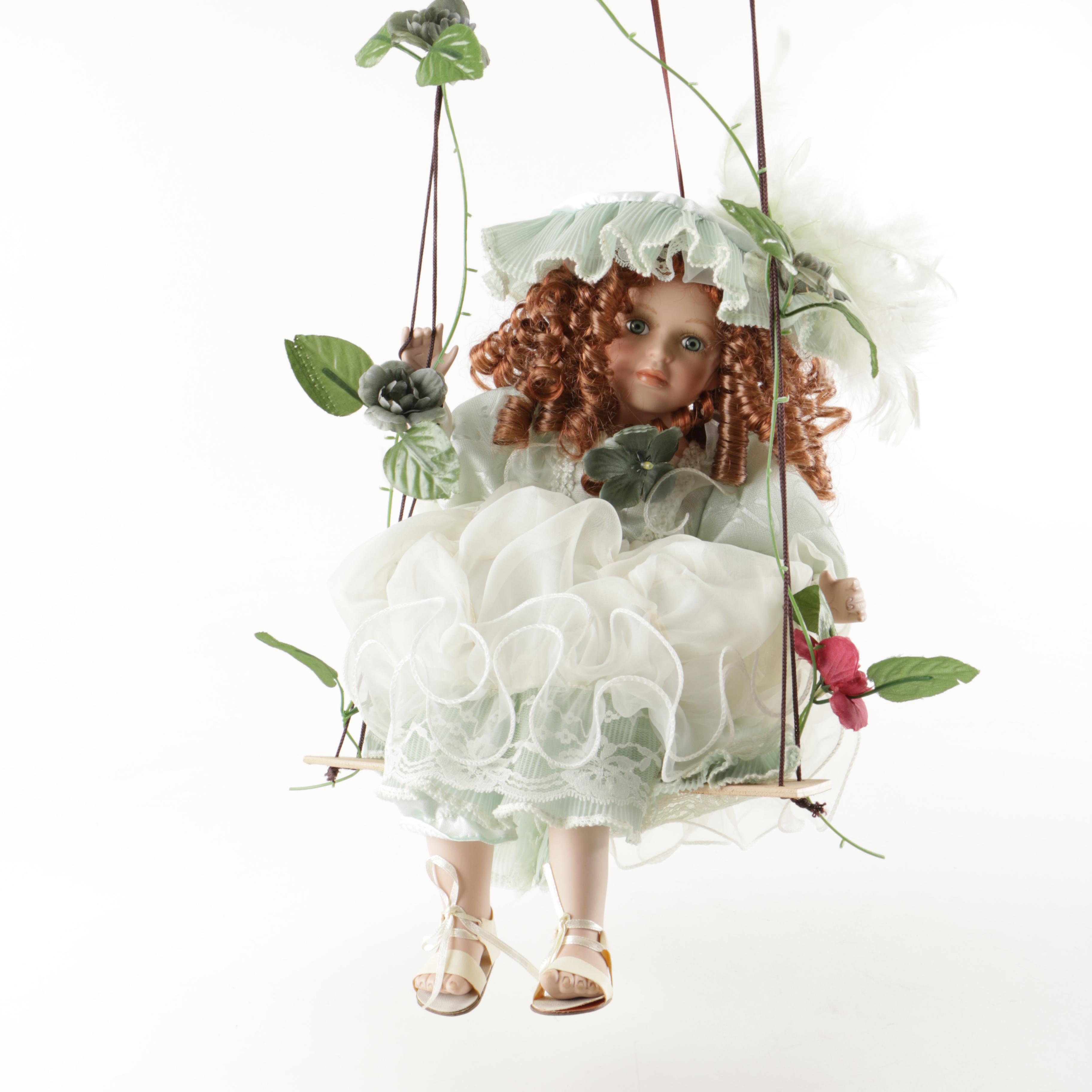 cathay collection porcelain doll on swing