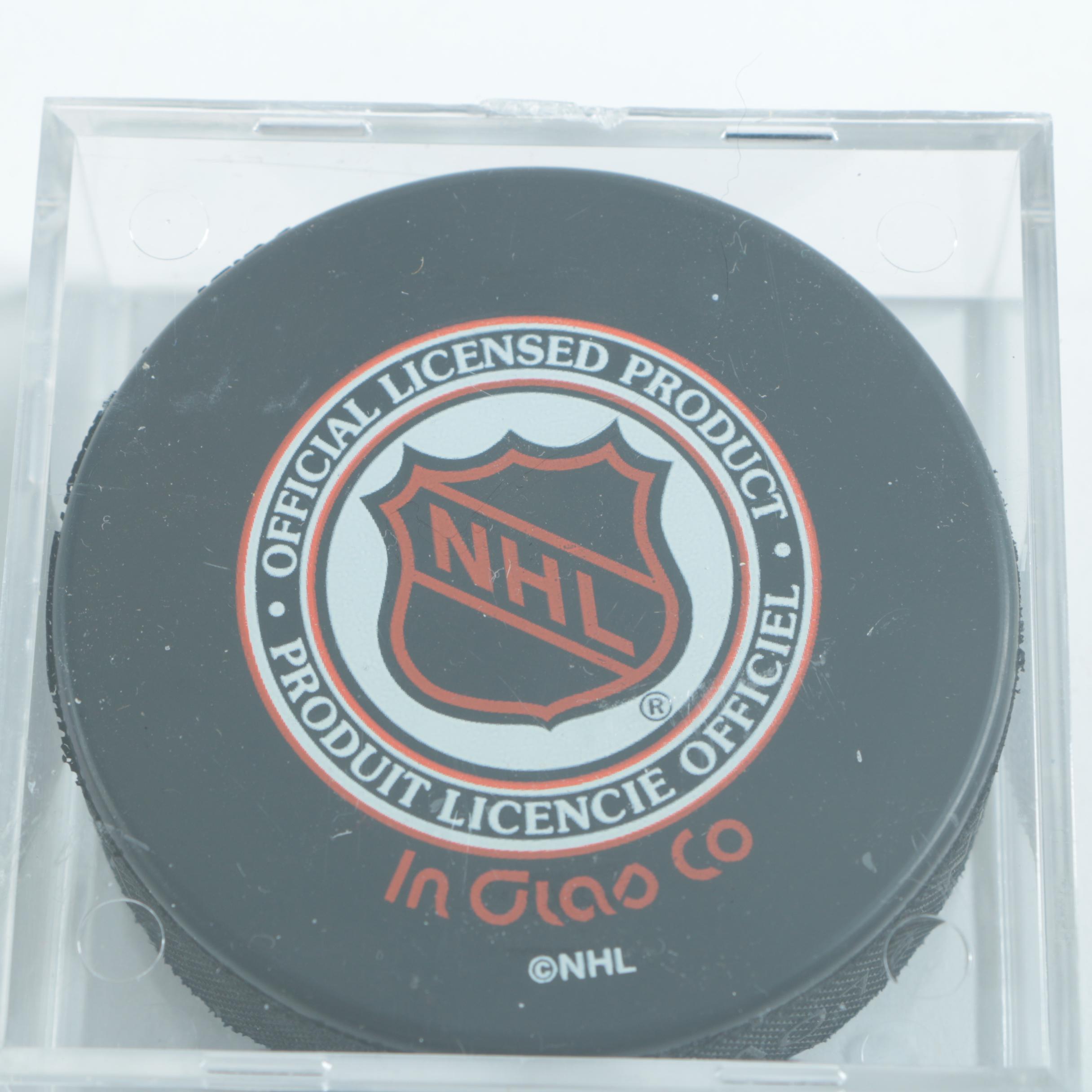 Autographed Chicago Blackhawks Hockey Pucks with 75th Anniversary Puck