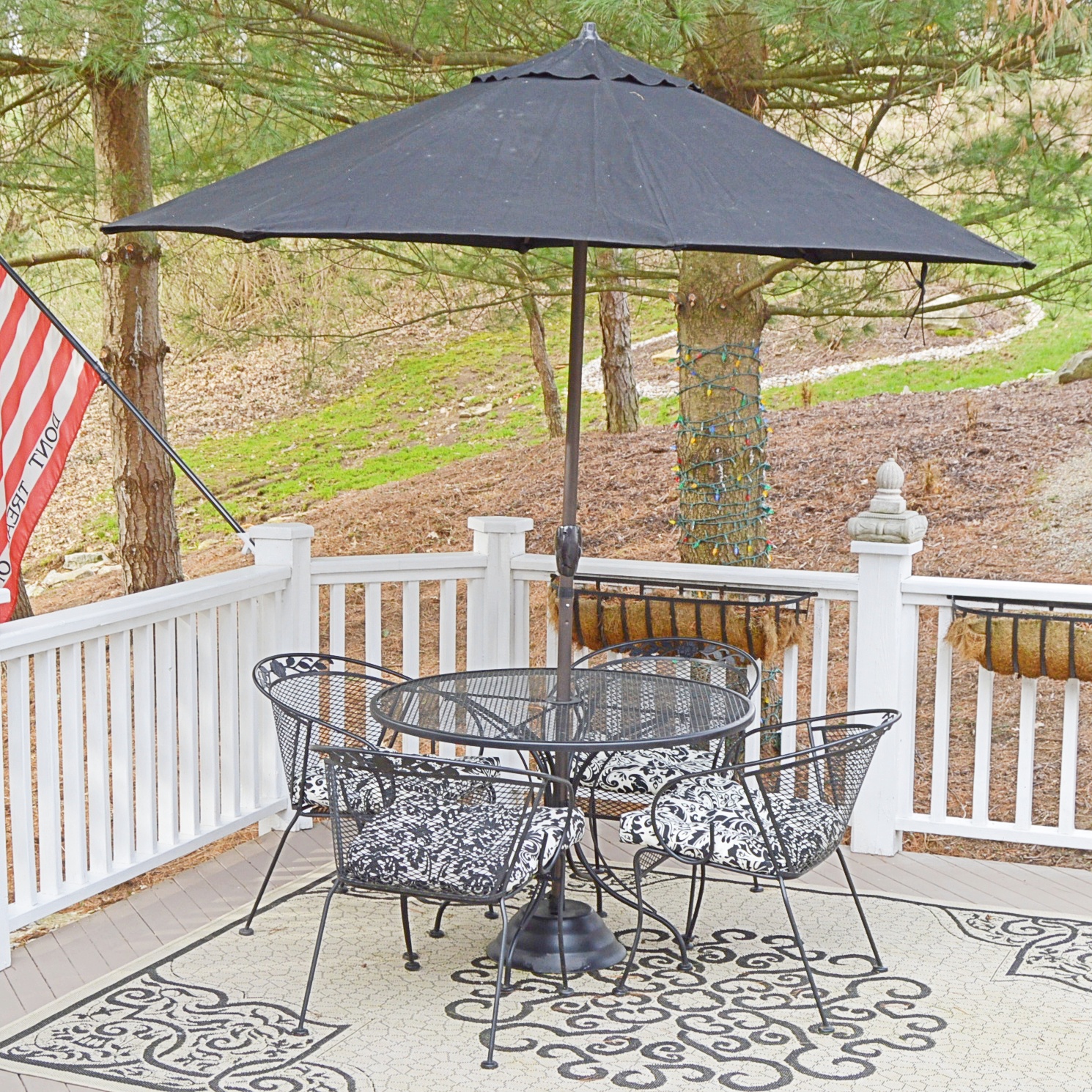 Metal Outdoor Dining Set With Umbrella And Woven Outdoor Rug Ebth