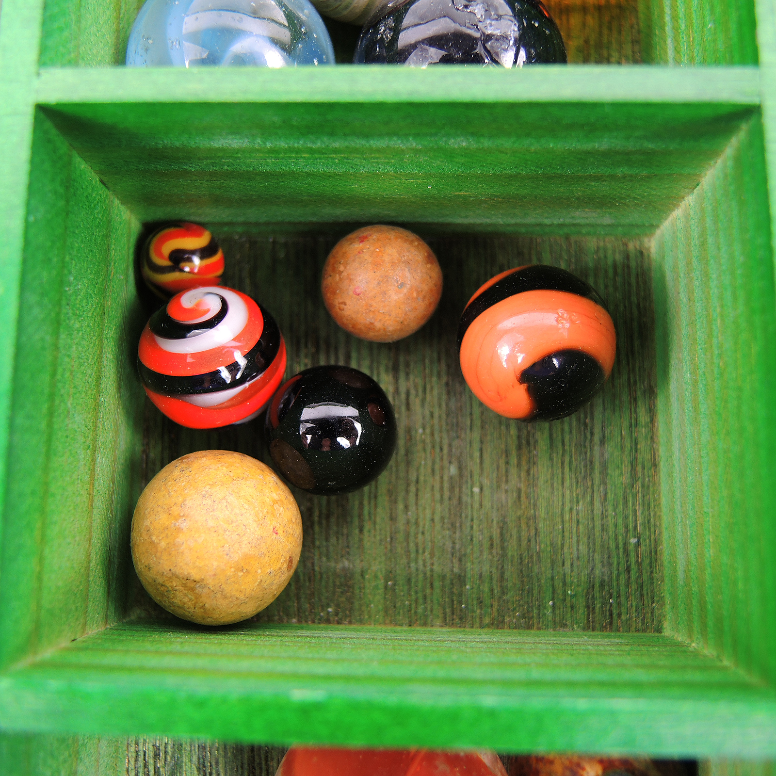 Glass and Clay Marbles with Corkscrews and Large Peppermint in Display