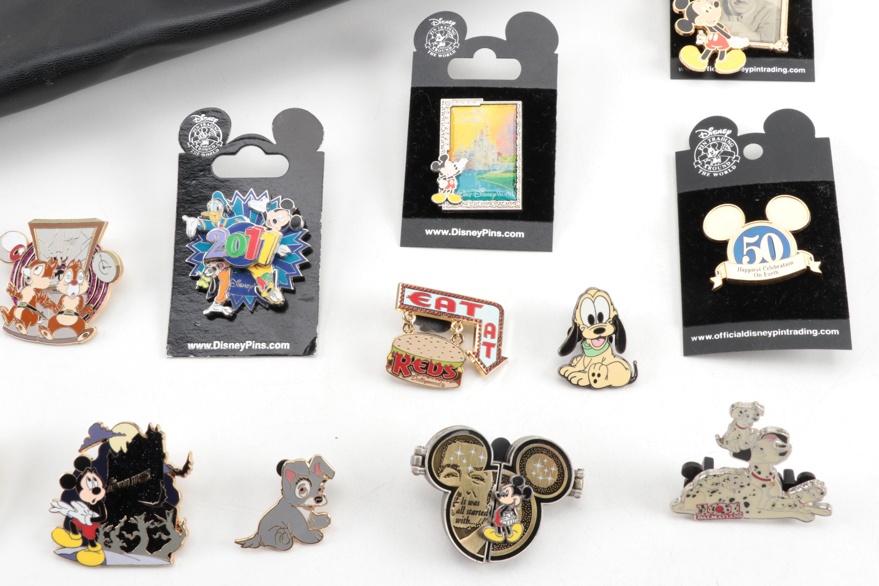 Walt Disney Collectibles Including Enamel Pins, Nesting Doll, and Door