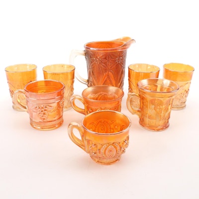 Imperial "Poinsettia" Pitcher with Other Marigold Carnival Glass Cups
