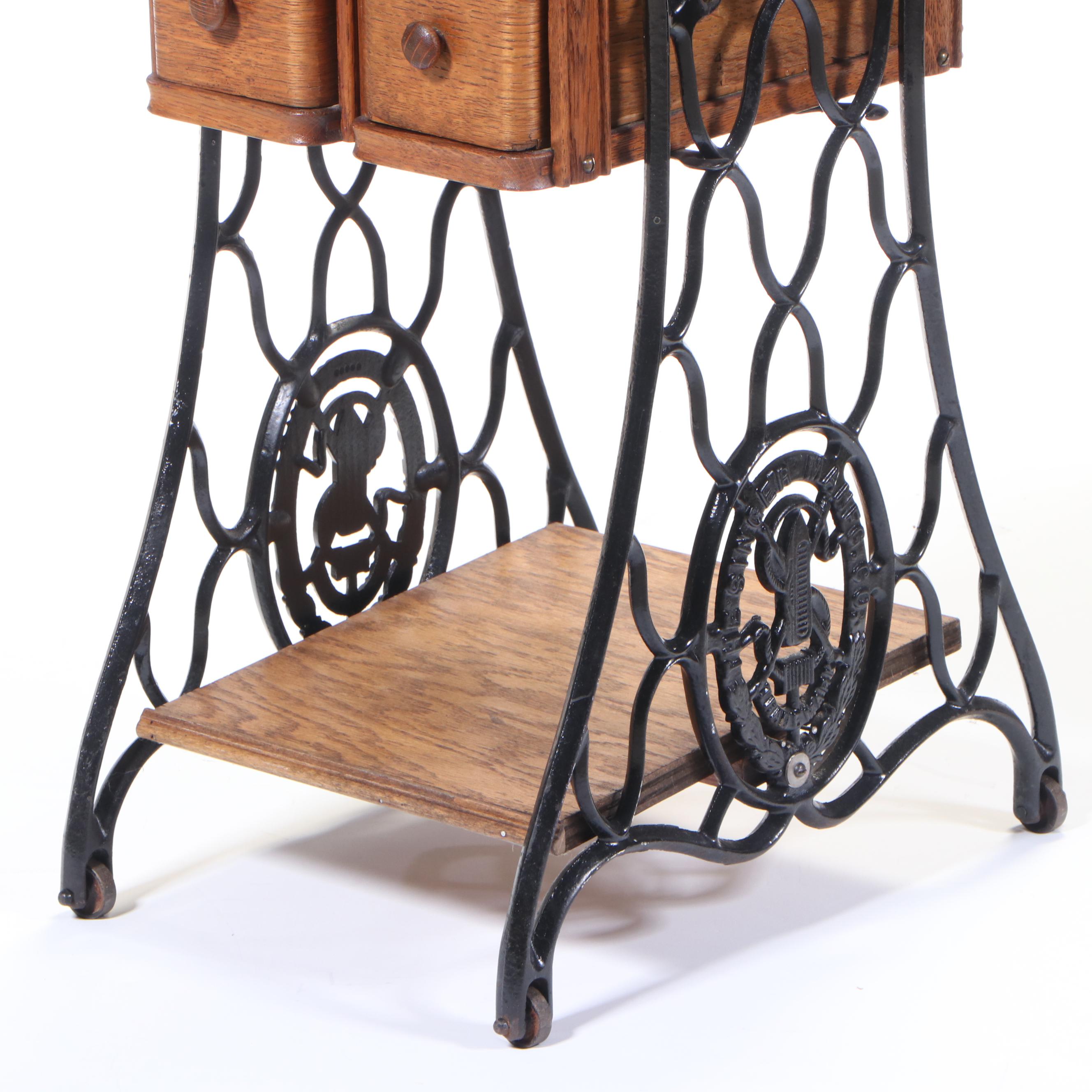 The Singer Mfg. Co. Oak and Cast Iron FourDrawer Side Table, Adapted