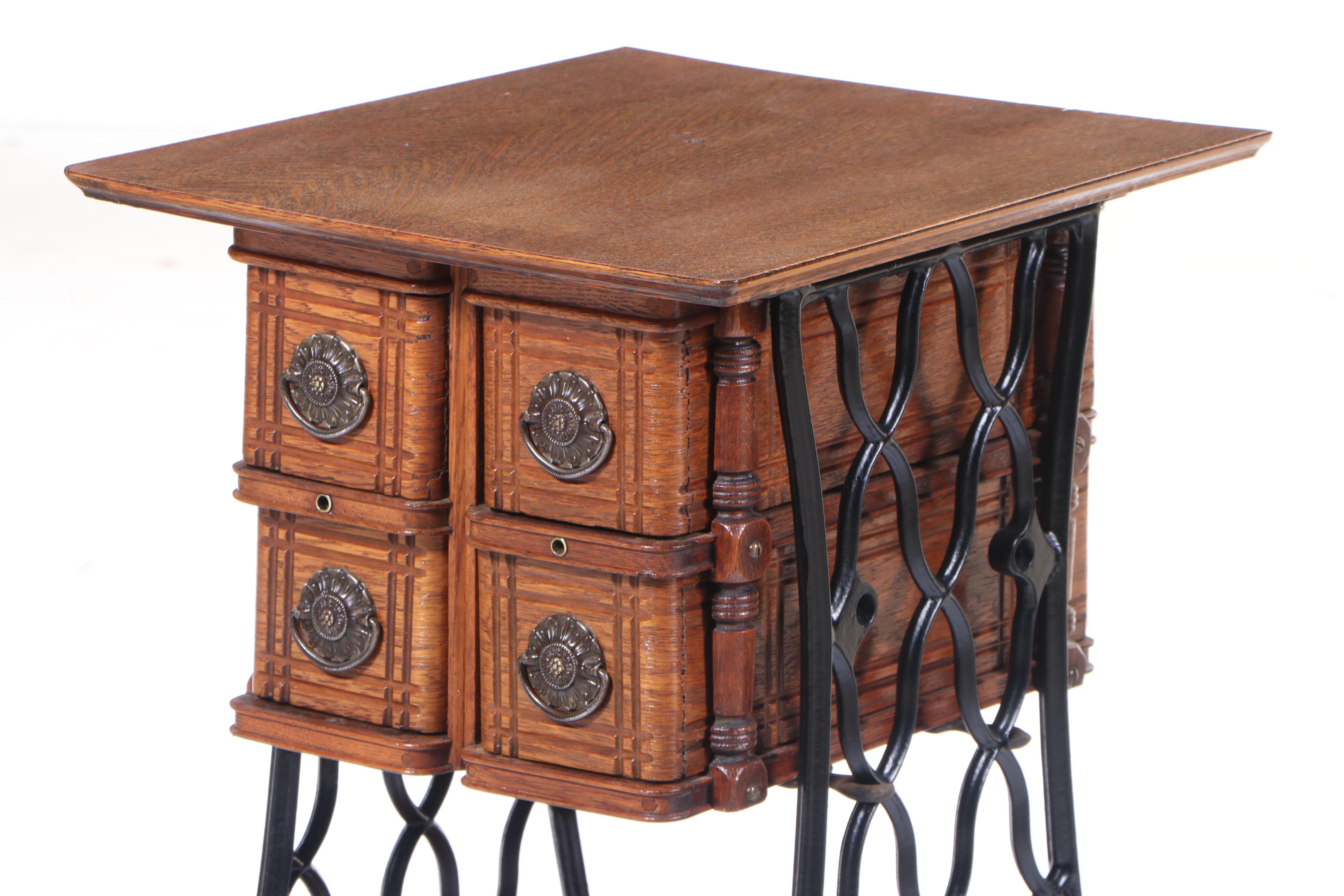 The Singer Mfg. Co. Oak and Cast Iron FourDrawer Side Table, Adapted