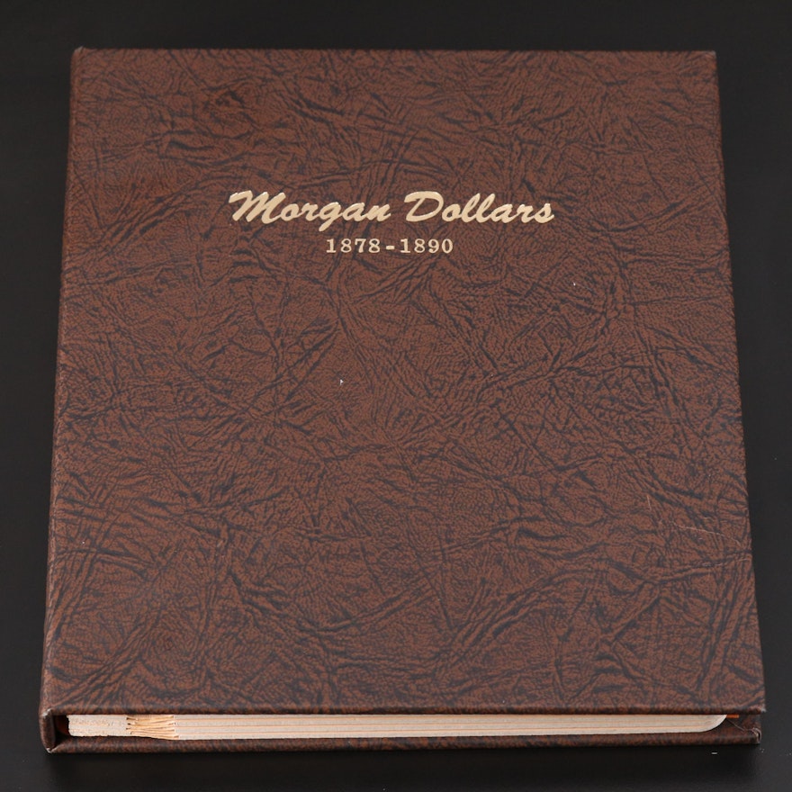 Twenty-six Morgan Silver Dollars in a Dansco Coin Folder