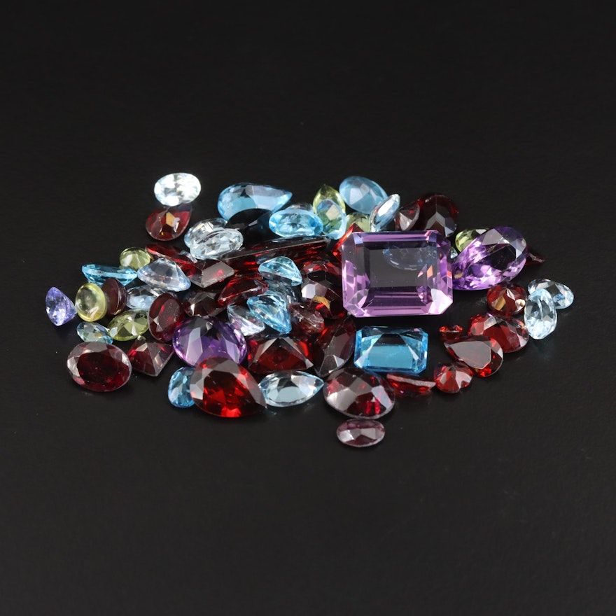 Loose 64.57 CTW Gemstones Including Swiss Blue Topaz, Amethyst and Garnet