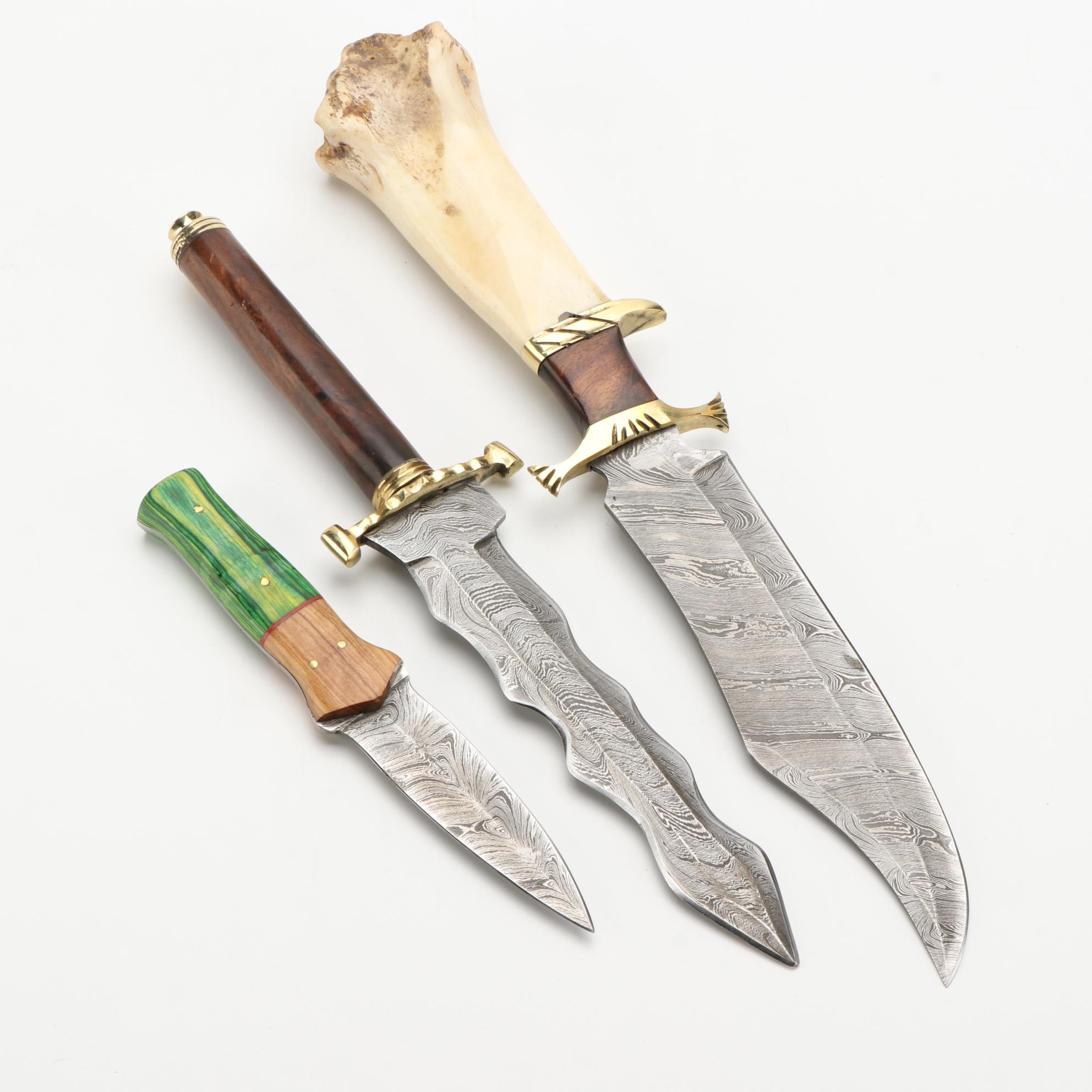Three Different Damascus Steel, Wood, and Bone Handled Kris Knives and