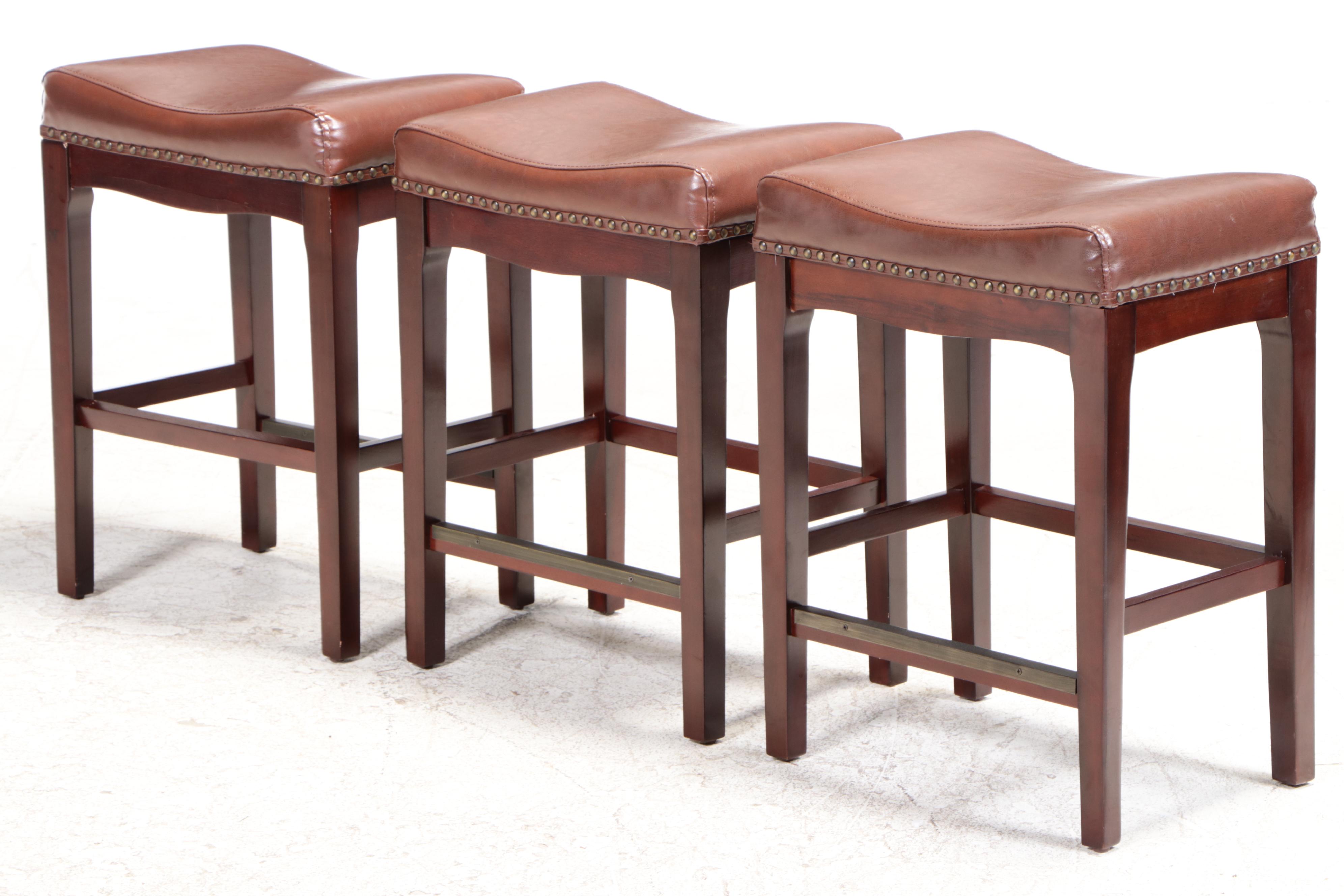 Three Bombay Company MahoganyStained and FauxLeather Counter Stools